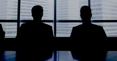 Silhouette row of businessmen sitting in meeting room