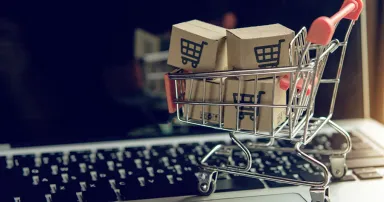 Shopping online. cardboard box with a shopping cart logo in a trolley on a laptop keyboard. Shopping service on The online web.