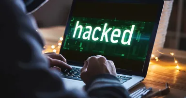A cyberpunk hacker wearing a hoodie with a face drawn on it in