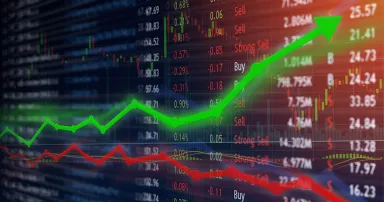 Investing and stock market concept gain and profits with faded candlestick charts.