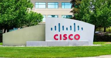 A sign with the Cisco logo is seen outside of a building