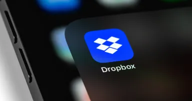 Dropbox mobile icon app on screen smartphone iPhone. Dropbox is file hosting company Dropbox Inc.