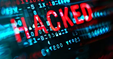 Detailed view of a computer screen with the word "HACKED" displayed prominently