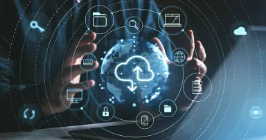 Hands surround a digital globe with cloud storage icons, on a dark background. Represents online data storage and security