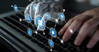 A robotic hand interacts with a laptop, surrounded by digital icons representing networks and artificial intelligence, showcasing future technology and innovation