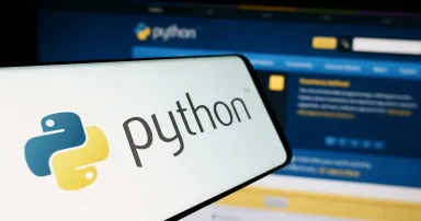 Smartphone with logo of organization Python Software Foundation (PSF) in front of website.