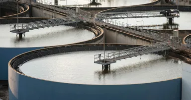 Modern urban wastewater treatment plant.Water purification is the process of removing undesirable chemicals, suspended solids and gases from contaminated water. Water cleaning facility outdoors.
