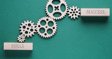 Abstract background with connected gears working together, from skills to success. Creative development process.