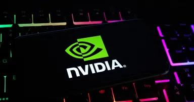 Closeup of mobile phone screen with logo lettering of nvidia corporation on computer keyboard