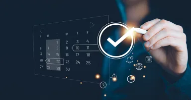 person typing on a touch screen schedule plan calendar.