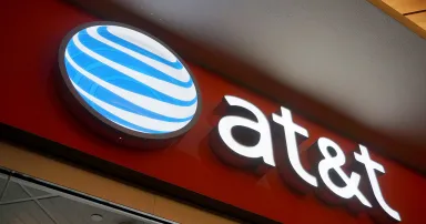 AT&T Logo sign on wall above store in Ala Moana Mall.