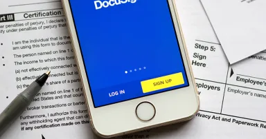 DocuSign mobile app login page is seen on a smartphone.