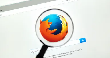 Firefox web browser under magnifying glass. Firefox is a free and open-source web browser developed by the Mozilla Foundation.