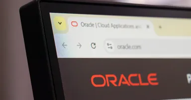 Oracle official cloud technology website homepage displayed on computer monitor with logo and dark interface.