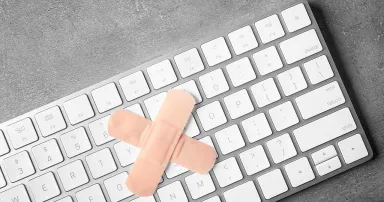 Two Band-Aids create an X on a computer keyboard