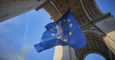 <p>A giant flag of the European Union flies at the Arc de Triomphe on the 20th anniversary of the introduction of the euro on Jan. 1, 2022, in Paris. (Photo by Kiran Ridley/Getty Images)</p>