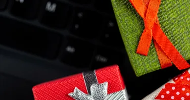 Small gift boxes arranged on the laptop keyboard. Cybersecurity of online shopping.
