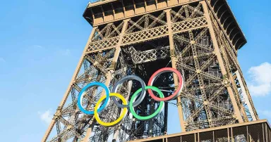 The multi-colored Olympic rings are seen on the Eiffel Tower in Paris
