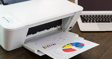 printer and Laptop on wood table