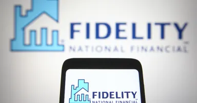 A Fidelity National Financial (FNF) logo is seen on a smartphone and a PC screen.