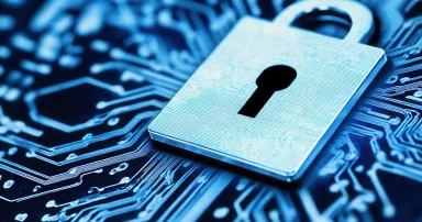 A digital lock rests prominently on a circuit board, symbolizing the importance of cybersecurity.