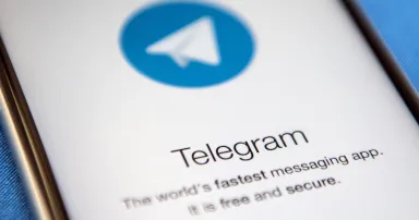 A close-up view of the Telegram messaging app is seen on a smartphone screen.