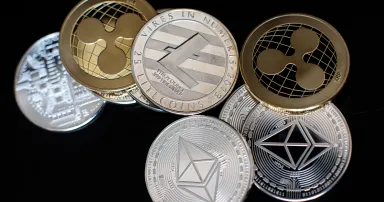 <p>The litecoin, ripple and ethereum cryptocurrency “altcoins” sit arranged for a photograph on April 25, 2018, in London. (Jack Taylor/Getty Images)</p>