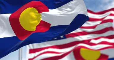 Colorado state flags waving along with the national flag of the United States