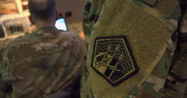 The Army Cyber Command patch is seen on the sleeve of a soldier