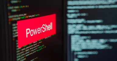 PowerShell inscription on the background of computer code.
