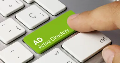 AD Active Directory written on green key of a computer keyboard.