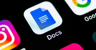 Google Docs icon seen close-up on a smartphone screen.