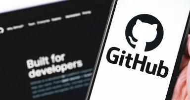 GitHub logo on the screen smartphone and notebook closeup. GitHub is the largest web service for hosting and developing IT projects.