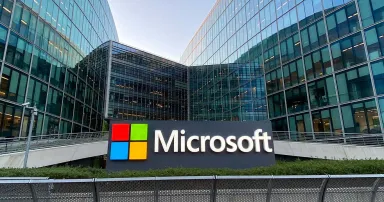 A sign with the red, green, blue and yellow Microsoft logo is seen outside a building