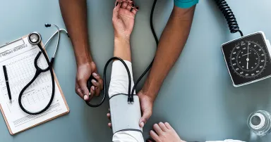 Nurse measuring patient blood pressure