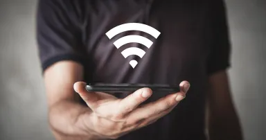 Man holding smartphone with wi-fi sign. Internet, Technology