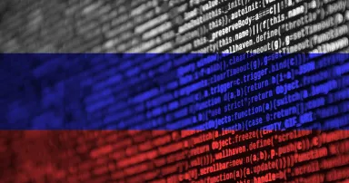 Russia flag is depicted on the screen with the program code. The concept of modern technology and site development.