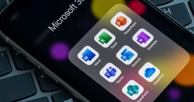 Premium Microsoft 365 apps are seen on an iPhone, including Word, Excel, PowerPoint, Teams, Outlook, OneNote, SharePoint, and OneDrive.