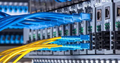 Fiber Optic cables connected to an optic ports and Network cables connected to ethernet ports