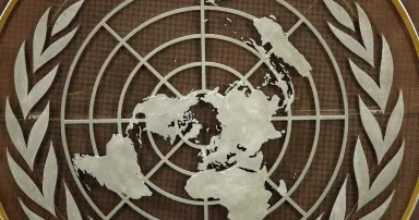<p>The logo of the United Nations is seen in the General Assembly hall before heads of state begin to address the 76th Session of the U.N. General Assembly at UN Headquarters on September 21, 2021 in New York City. International and cyber policy experts are grappling with how much involvement private industry should have when it comes to shaping cyber norms. (Photo by Eduardo Munoz-Pool/Getty Images)</p>