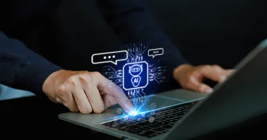 Man using laptop to chat with AI Chatbot Assistant or Artificial Intelligence Technology, Hologram Robot Application and Global Connectivity