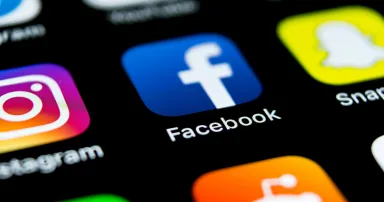 Facebook application icon on Apple iPhone screen close-up. Facebook app icon.