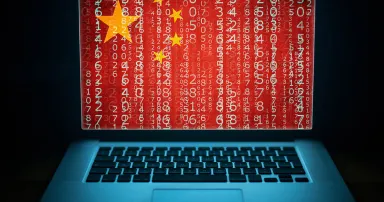 Chinese hacker. Laptop with binary computer code and china flag