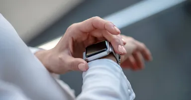 Gadget. Close up picture of a womans hands touching a smartwatch