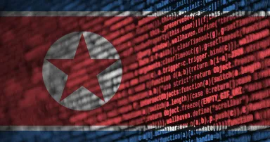 North Korea flag is depicted on the screen with the program code. The concept of modern technology and site development