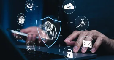 AI cybersecurity protection concept. Man using laptop, shield interface, threat detection, access control, cloud security, data privacy, email protection, authentication, secure network technology