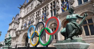 The multi-colored, intertwined Olympic rings are seen outside a hotel in Paris