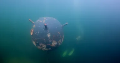 Old russian Anchor contact mine and scubadiver