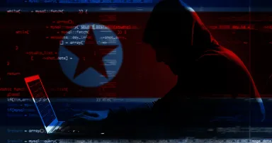 Double exposure of hacker working with laptop and flag of North Korea. Threat of cyber attack