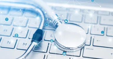 Stethoscope on the silver computer keyboard-blockchain data encryption